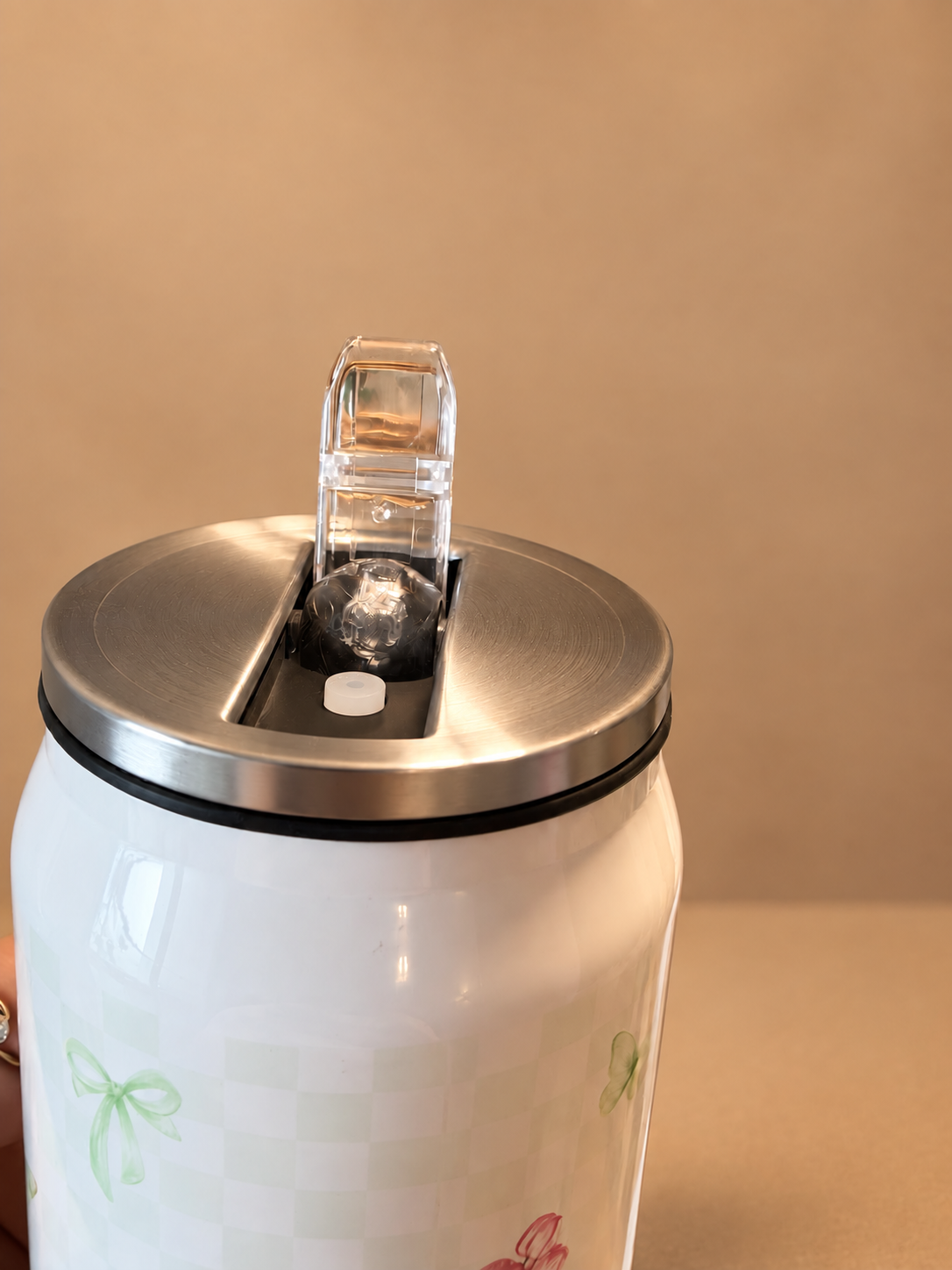Close-up of the Fiora metal can sipper lid with its transparent flip-up cover open. Shop Kamashh India